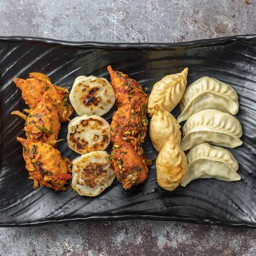 a plate of momos on a table